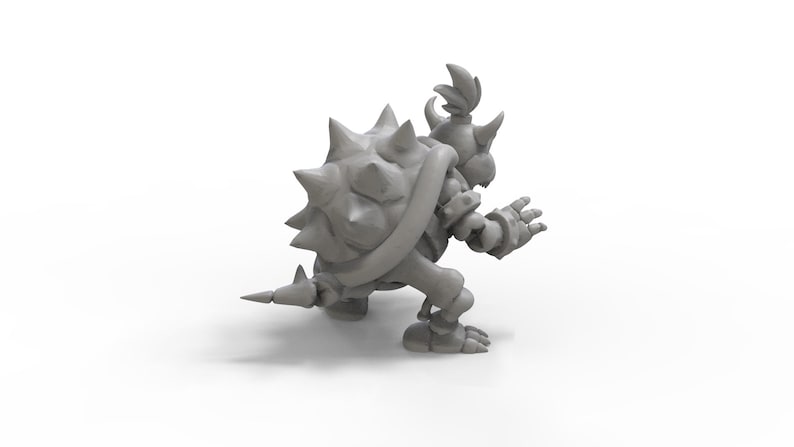May include: A grey 3D printed figurine of a spiky, turtle-like character with a crown and a spiked tail. The character is in a crouching pose with its arms outstretched.