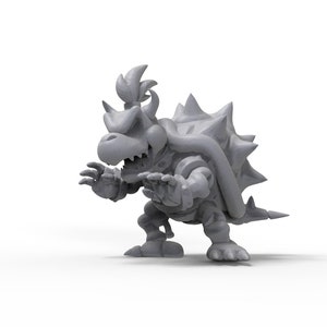 May include: A grey 3D printed model of a Bowser character from the Super Mario Bros. video game series. The model is posed in a menacing stance with its mouth open and claws extended.