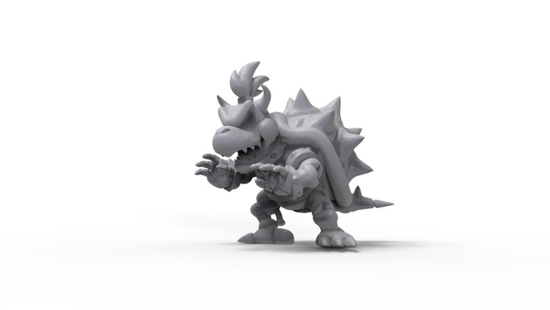 May include: A grey 3D printed model of a Bowser character from the Super Mario Bros. video game series. The model is posed in a menacing stance with its mouth open and claws extended.