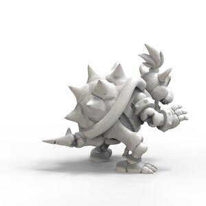 May include: A white 3D printed model of a turtle-like character with a spiky shell and a crown. The character is in a running pose with its arms outstretched.