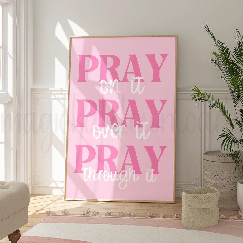 May include: Pink and white inspirational quote poster with the text "Pray on it Pray over it Pray through it".
