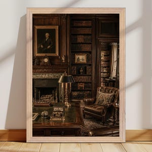 May include: A framed wall art print depicting a dark wood-paneled library interior. The scene features a leather armchair, a large desk with a green top, a fireplace with a mantel clock, tall bookshelves filled with books, and a portrait painting.