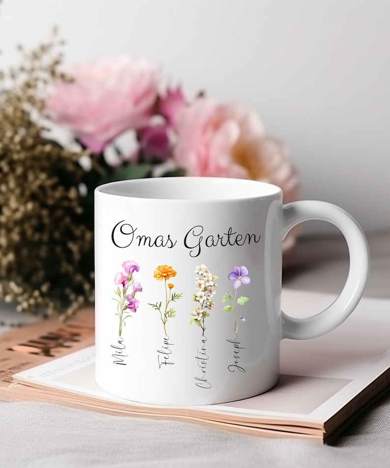 May include: White ceramic mug with a floral design and the text "Omas Garten" at the top.  Four flowers are depicted with the names Mila, Felipe, Christina, and Joseph written below each flower.
