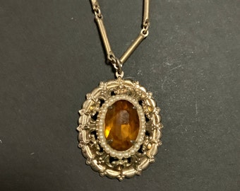 Coro vintage pendant necklace with topaz rhinestone in gold setting.