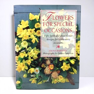 May include: A book titled "Flowers for Special Occasions" with a floral arrangement on the cover. The cover features yellow flowers and green foliage. The book's title is in red and white text. The author is Fiona Barnett.