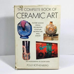 May include: A vintage book titled "The Complete Book of Ceramic Art" by Polly Rothenberg. The cover features ceramic art examples, including pottery, sculpture, and jewelry. The book has 690 photographs and 18 color plates.