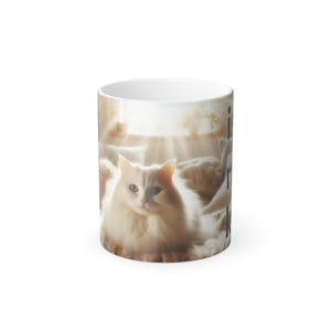 May include: White ceramic mug with a fluffy white cat design. The cat is in a sunlit setting. The mug has the text "is my cat" printed vertically on the side.