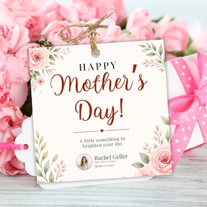 May include: A Mother's Day gift tag with the text "HAPPY Mother's Day!" and floral accents. A pink ribbon is attached to a gift box with a polka dot bow. Pink flowers are in the background.