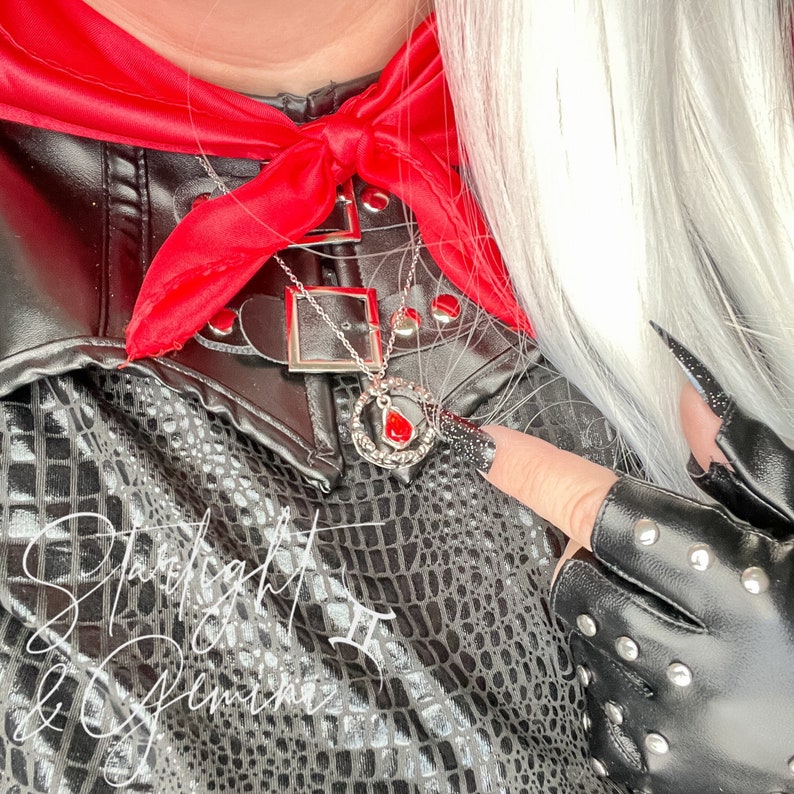 Manon Blackbeak from Throne Of Glass wearing the Hello Princeling necklace for Dorian Havilliard, of a crown with a red gem