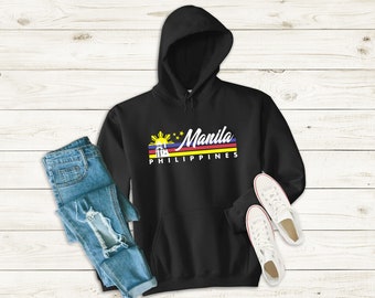 May include: Black hooded sweatshirt with a white graphic print of a sunset with a building and the text "Manila Philippines".