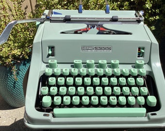 Vintage Hermes 3000 manual portable typewriter with original case and brush