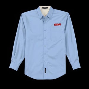 May include: A light blue button-down shirt with long sleeves. The shirt has a white collar and a red "SDN" logo on the chest pocket. The shirt is buttoned up and has a small tag near the bottom.