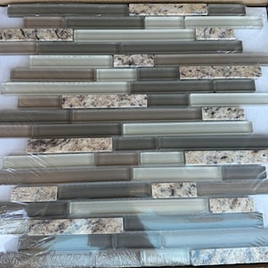 May include: A sheet of gray and white glass mosaic tiles with a granite pattern. The tiles are arranged in a staggered pattern.