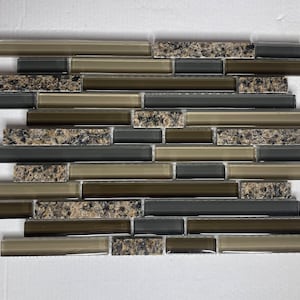 May include: A mosaic tile sheet with a mix of brown, gray, and black glass tiles. The tiles are arranged in a staggered pattern, creating a modern and stylish look.
