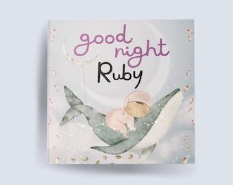 May include: A blue whale with a baby sleeping on its back. The whale is flying through the air with a crescent moon and stars in the background. The text "good night Ruby" is written on the page.