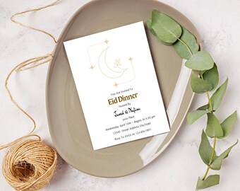 May include: A white invitation card with a gold crescent moon and stars design. The text reads "You Are Invited To Eid Dinner Hosted By Javed & Nafisa xxxx Place Wednesday April 10th - Begins At 5:30 pm 12345 Street Address City State Rsvp To XKKK A1 123 456 7891"