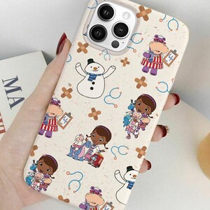 May include: A white ceramic mug with a black handle and the text "But First, Coffee" in a black, handwritten-style font. The mug is on a white surface.