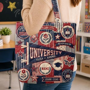May include: A quilted tote bag featuring a patchwork design with navy, red, and white stripes, stars, and floral patterns. The bag displays a large pennant with the text UNIVERSITY and ELIZA J. ADAMS, along with emblems reading CLASS OF 2026, NAME, and LEARN LEAD.