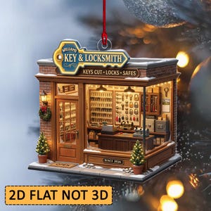 May include: A 2D flat hanging ornament shaped like a locksmith shop with a brick exterior, a red string, and a sign reading WILLIAMS KEY & LOCKSMITH KEYS CUT LOCKS SAFES. The interior displays shelves of keys, tools, and safes with warm lighting.