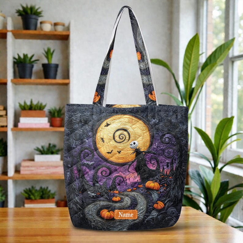 May include: A tote bag featuring a dark, swirling landscape with a large yellow moon, a skeletal figure, and orange pumpkins. The design includes a rectangular patch with the text Name. The bag has two long shoulder straps and a quilted texture.