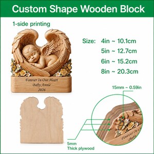 May include: A custom wooden block with a carved angel design. The block features a sleeping baby within angel wings, with the text "Forever In Our Heart Baby Annie 2026." Sizes range from 4 inches (10.1cm) to 8 inches (20.3cm).