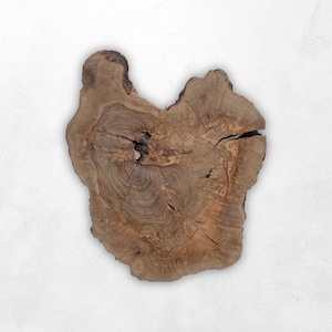 May include: A natural wood slice with a unique, irregular shape. The brown surface displays visible wood grain, knots, and cracks, creating a rustic aesthetic. The wood slice is likely used for serving or decorative purposes.