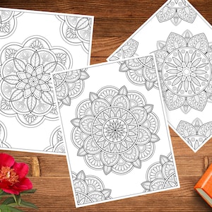 May include: Three printable coloring pages featuring intricate mandala designs. Each page has a different mandala pattern with detailed lines and swirls.