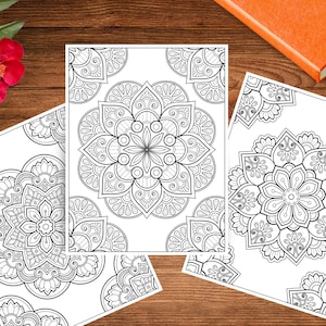 May include: Three black and white printable coloring pages featuring intricate mandala designs. Each page features a different mandala design with detailed patterns and swirls.