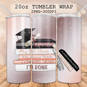 May include: A 20oz tumbler wrap design featuring a graduation cap, diploma, and books with the text "GRADS", "My last class", "My memory book", "Congrats Grad", and "I'm done". The background is a pink and white ombre with glitter.