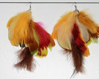 May include: A pair of feather earrings with a mix of yellow, orange, red, brown, and white feathers.
