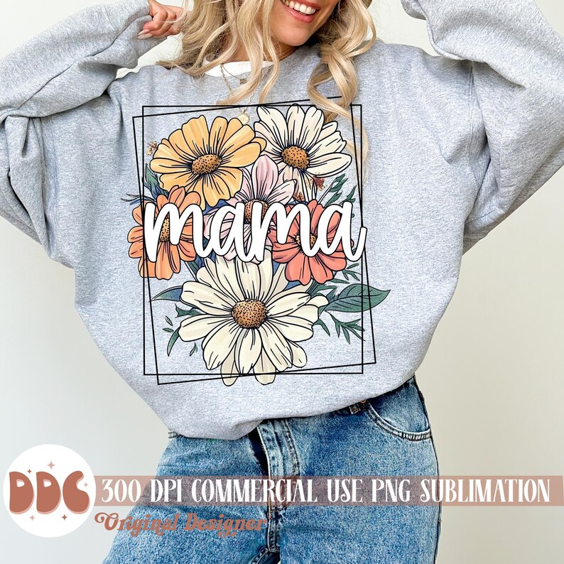 May include: A grey sweatshirt featuring a floral design and the word "mama" in white lettering. The flowers are in shades of yellow, orange, pink, and white.