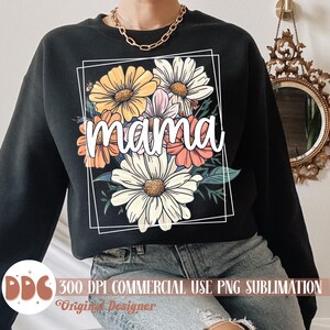 May include: Black sweatshirt featuring a floral design and the word "mama" in white lettering.