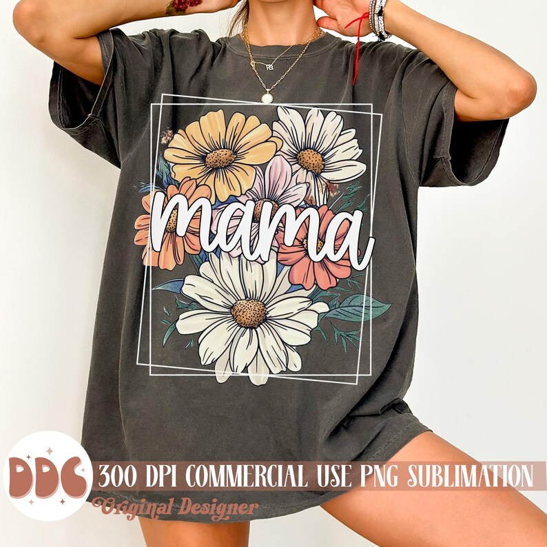 May include: A grey t-shirt featuring a floral design and the word "mama" in white text. The flowers are in shades of yellow, pink, orange, and white.