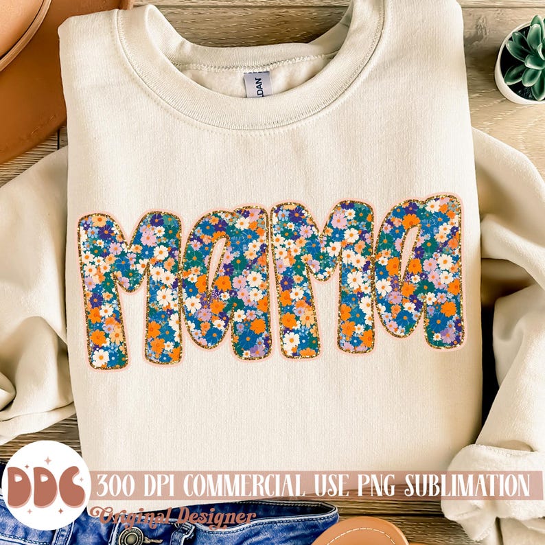 May include: A beige sweatshirt with the word "Mama" in large, colorful letters. The letters are covered in a floral pattern with orange, blue, and purple flowers. The text "300 DPI COMMERCIAL USE PNG SUBLIMATION" is at the bottom of the image.