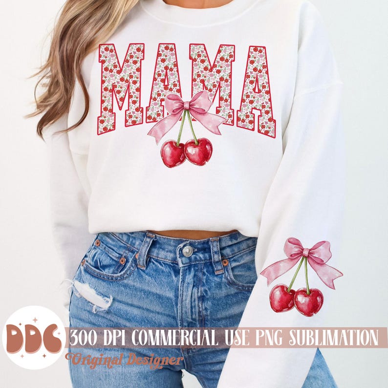 May include: White sweatshirt with the word "MAMA" in red block letters filled with a floral pattern. A pink bow and two cherries are centered below the word. A matching cherry and bow design is on the sleeve.
