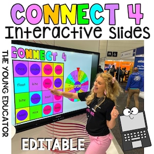 May include: A woman stands in front of a large interactive screen displaying a Connect 4 game with a colourful wheel spinner. The screen shows the words "CONNECT 4" and "THE YOUNG EDUCATOR". The game board has words like "rice", "snake", "feet", "goat", "float", "kite", "key", "take", "bite", "honey", "boat", "boat", "nice", "make", and "keep". The wheel spinner has the word "SPIN!" in the centre. The woman is pointing at the wheel spinner with her right hand. The screen is labelled "EDITABLE".
