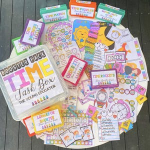 May include: A colorful set of educational time-telling activities for kids. The set includes a variety of games, puzzles, and cards, all designed to help children learn about time. The set is packaged in a clear plastic box with the words "Booster Pack Time Task Box The Young Educator" printed on the front.
