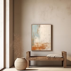 Puede incluir: Un banco de madera con un cojín se encuentra frente a una pared beige con una pintura abstracta en un marco marrón. La pintura presenta tonos de azul, blanco y naranja.