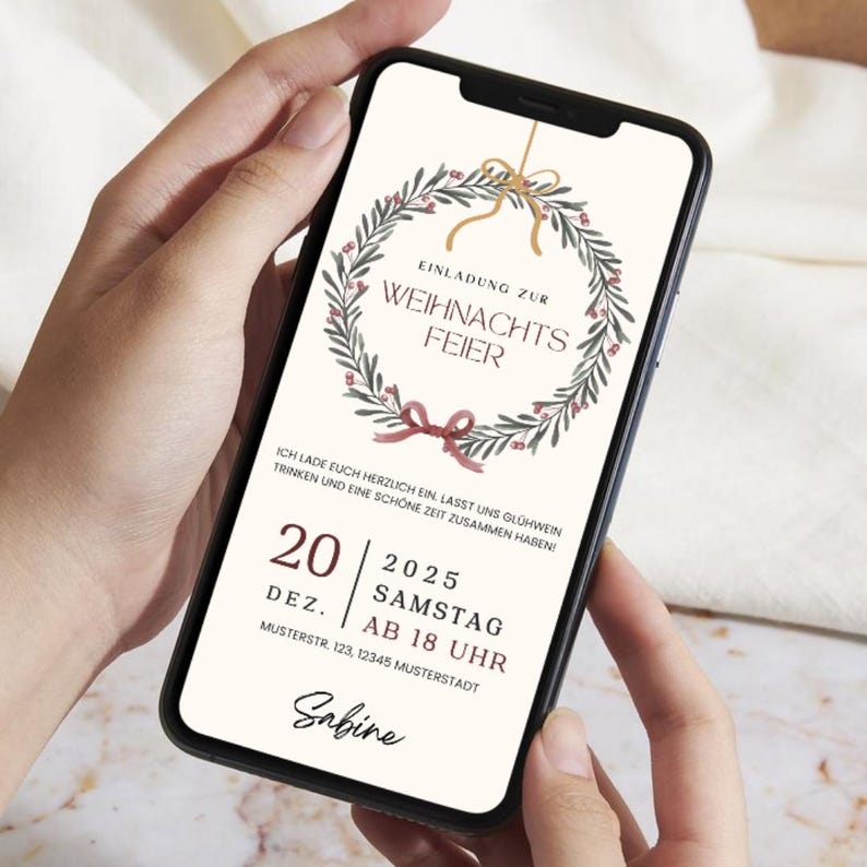 May include: A smartphone displays a Christmas party invitation. The design features a wreath with berries and a bow, with text in German. The invitation includes the date, time, and location for the event.
