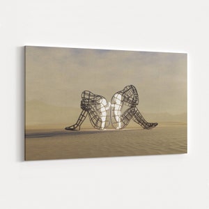 May include: Two wire frame sculptures of people sitting back to back, facing opposite directions. The sculptures are in a desert landscape with a light brown background. The sculptures are made of metal and are illuminated from within, creating a glowing effect.