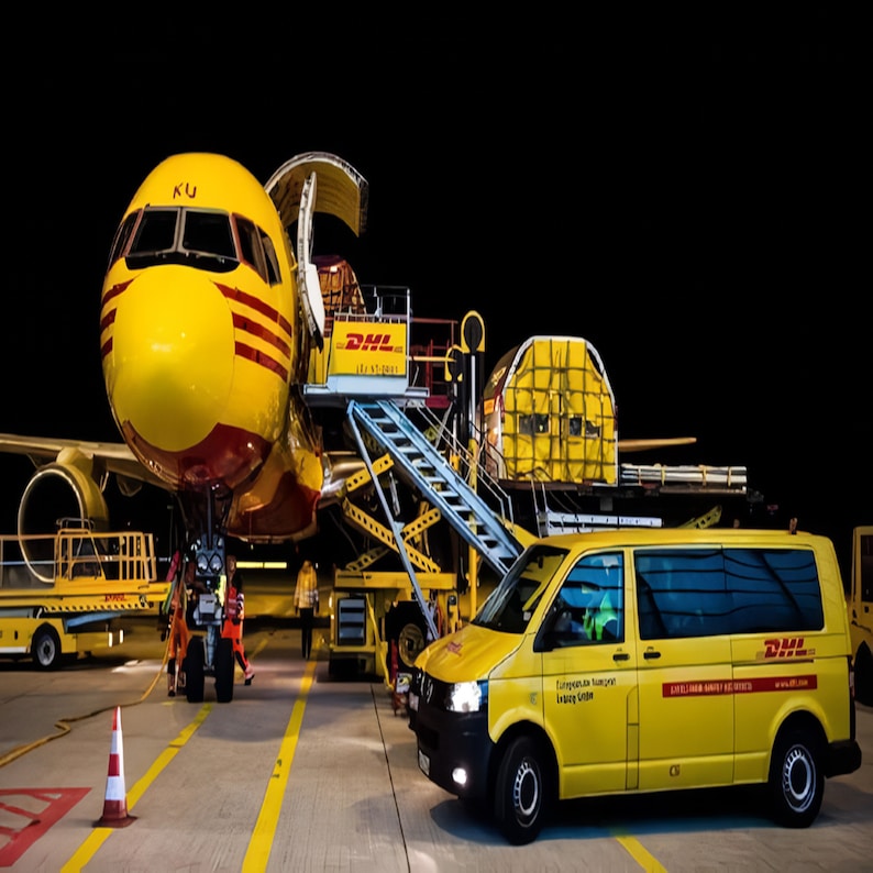 May include: A yellow DHL cargo plane with its cargo door open is being loaded by a yellow DHL van. The plane is parked on a tarmac with a yellow loading ramp and a yellow DHL ground crew vehicle.