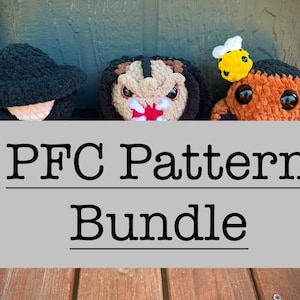 Può includere: Tre bambole all'uncinetto fatte a mano. Le bambole includono un cappello nero, un personaggio ispirato a Predator e una bambola con un'ape sulla testa. Le bambole sono davanti a un cartello grigio con la scritta "PFC Pattern Bundle".