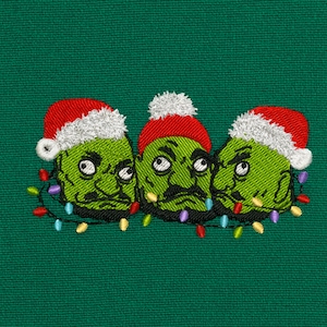 May include: Embroidered design featuring three green faces with Santa hats and mustaches, each adorned with a string of colorful Christmas lights. The design is set against a green fabric background, creating a festive holiday theme.