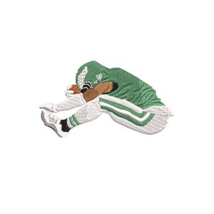 May include: An embroidered patch featuring a football player in a green uniform with white and black accents, holding a brown football. The player is in a diving position, with the ball tucked against their body.