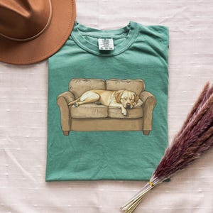 Comfort Colors t-shirt with yellow Labrador retriever sleeping on couch graphic design.