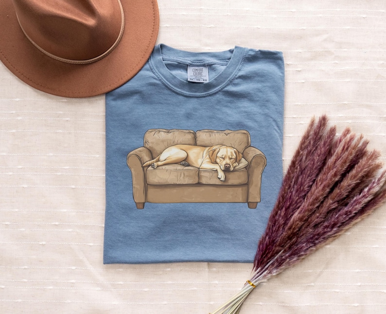 Comfort Colors t-shirt with yellow Labrador retriever sleeping on couch graphic design.