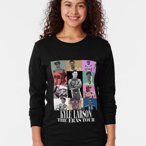 May include: Black long-sleeve shirt featuring a grid of images of Kyle Larson, with the text "KYLE LARSON THE ERAS TOUR" in white. The images have colorful backgrounds. The shirt is worn by a person.