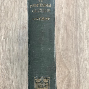 May include: A dark green hardback book spine titled Introduction to Infinitesimal Calculus by G.W. Caunt. The spine features gold lettering and a gold crest at the bottom with the text Dominus Illuminatio Mea and the word Oxford at the base.