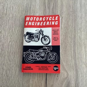May include: A red and black book titled "Motorcycle Engineering" with a picture of a motorcycle on the cover. The book is published by Clymer Publications and costs £5.00. The book features over 175 photos and charts.