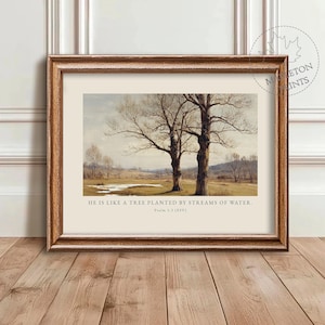 May include: Framed art print featuring a landscape painting of two bare trees in a field. The artwork has a neutral color palette with a light beige background. Text at the bottom reads: "HE IS LIKE A TREE PLANTED BY STREAMS OF WATER. Psalm 1:3 (ESV)."